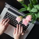 This stock-photo “blogger” can afford both fresh-cut flowers and a latte.